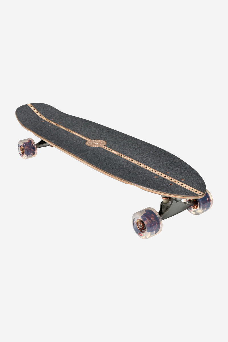 Angled view of Forager Mesa cruiserboard 34 showing dark deck with central wood inlay and magnesium trucks