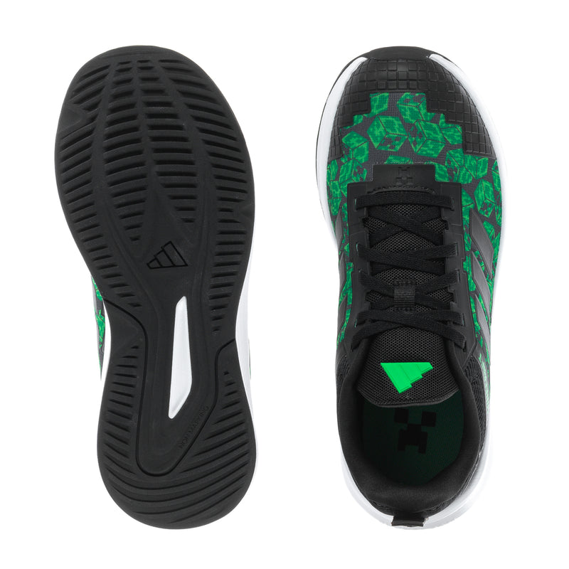 Youth sneaker outsole and heel view, black tread with green graphics and white edge
