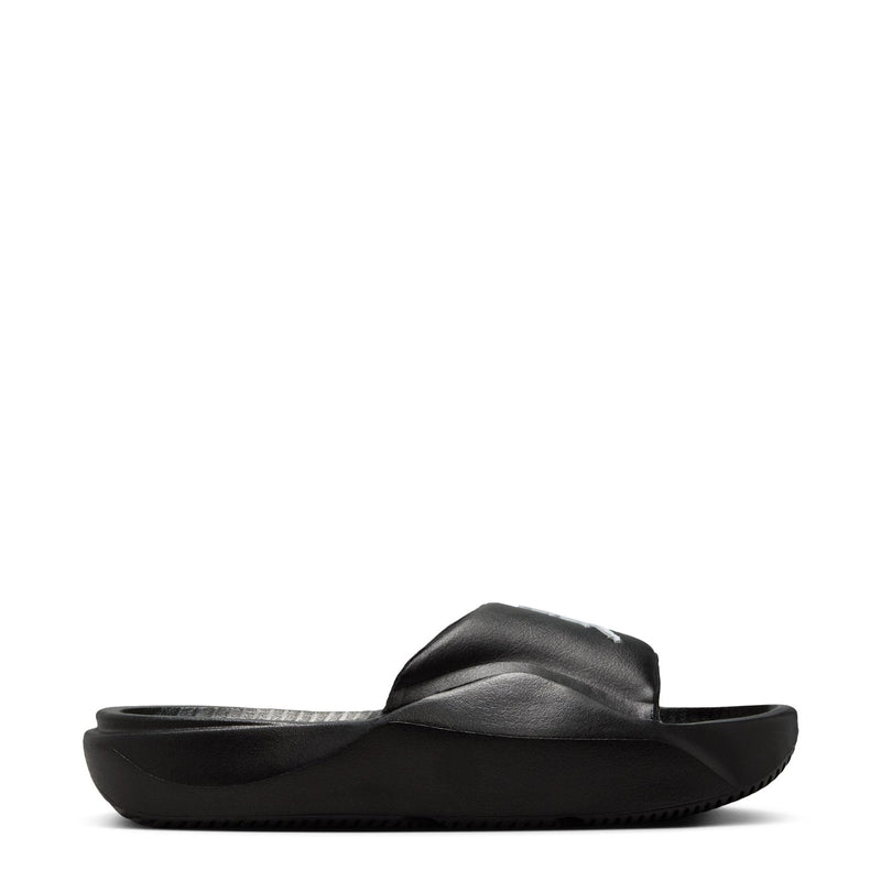 Black youth slide sandal with cushioned footbed and wide strap, side profile.
