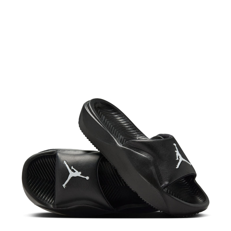Black youth slide sandals with white Jordan logos on the sides, open-toe view.