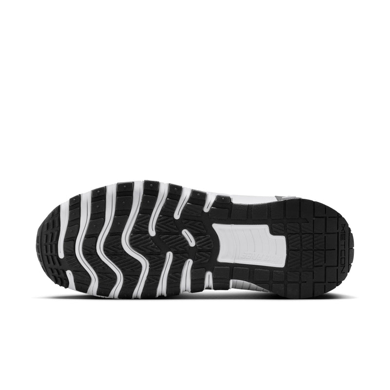 Bottom view of men's black sneakers with white traction grooves and rubber pods