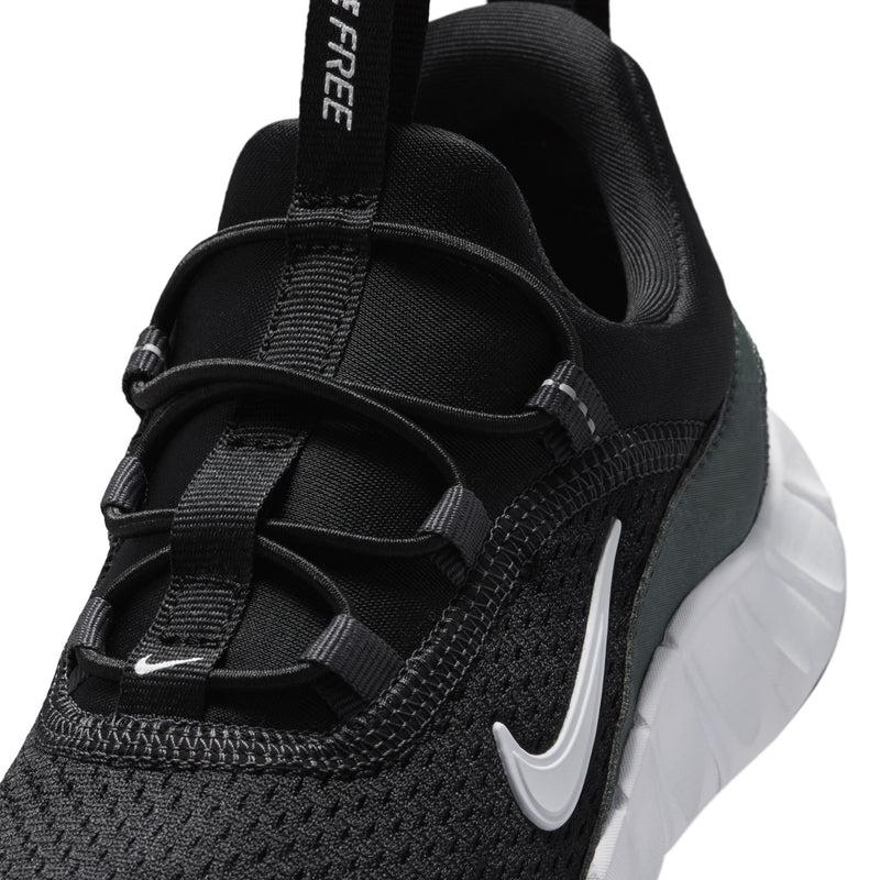 Kids' black sneaker upper close-up with laces, padded collar, and Nike Swoosh