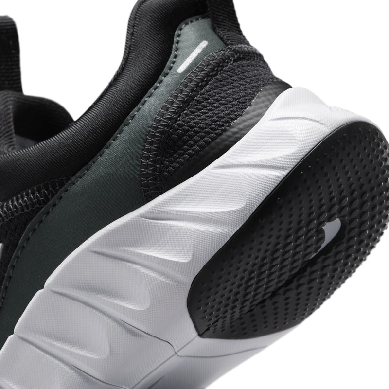 Kids' sneaker close-up showing black knit upper and textured white outsole