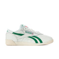 Women's white Reebok Freestyle Lo low-top sneakers with green stripe accents