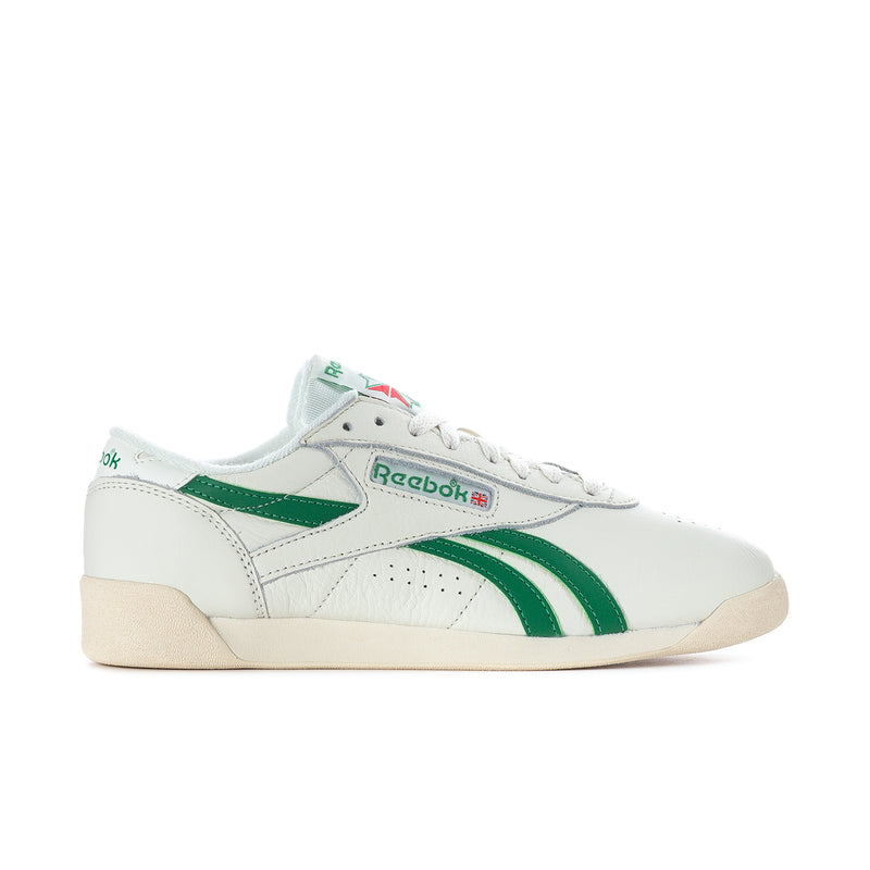 Women's white Reebok Freestyle Lo low-top sneakers with green stripe accents