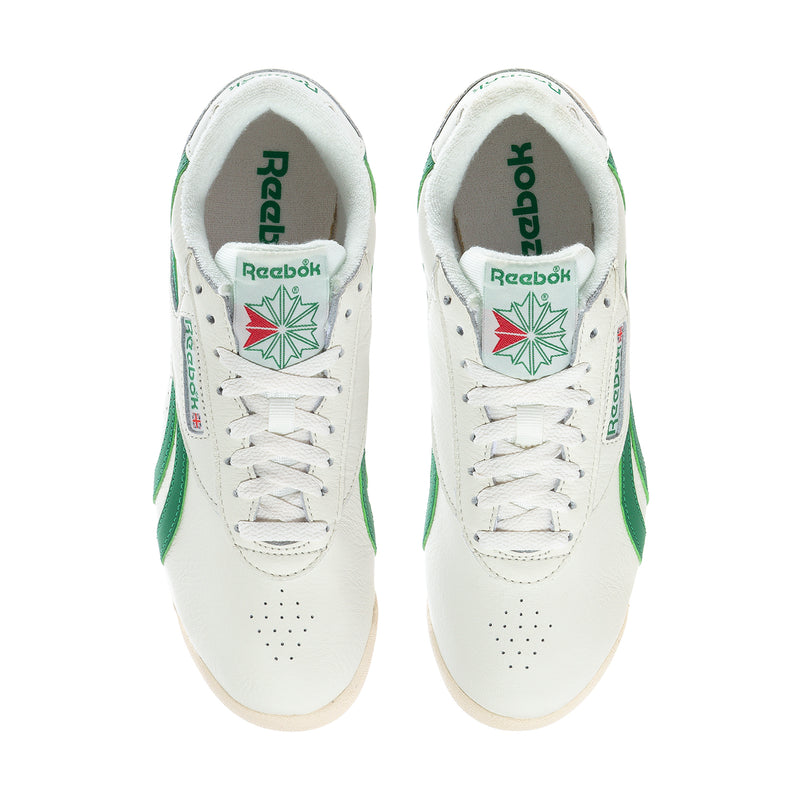 Pair of white Reebok low-top sneakers with green heel tabs and white laces