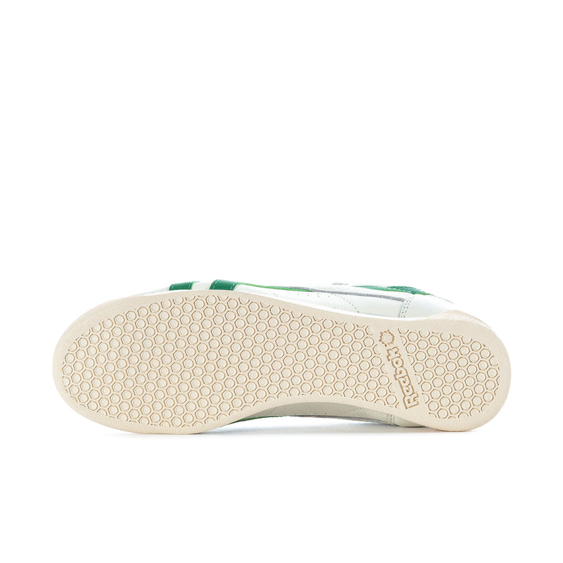White Reebok sneaker outsole with tan gum texture and green heel detail