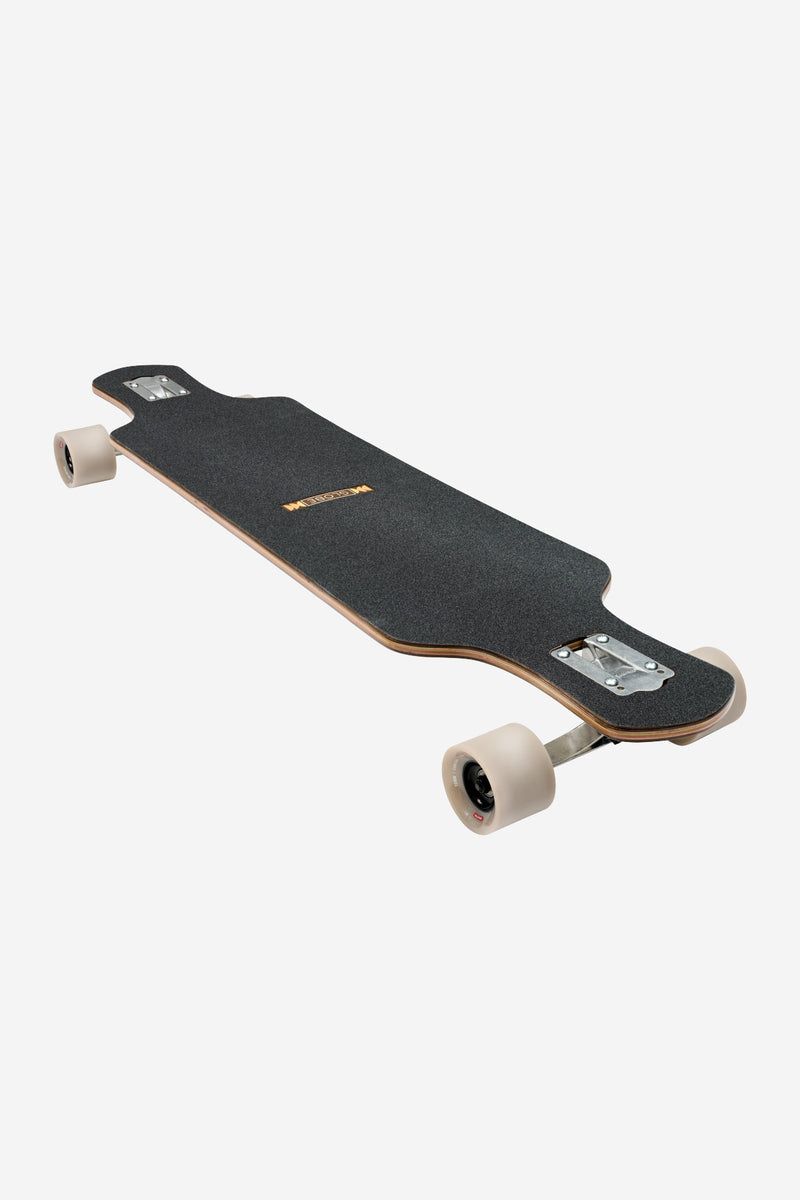 Geminon 40 Rock longboard deck with dark grip tape and drop-through trucks seen from above.
