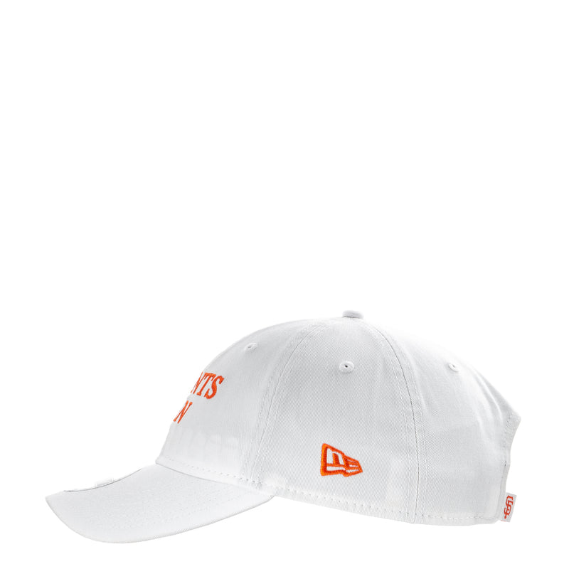White baseball cap with orange logo accents and side tag