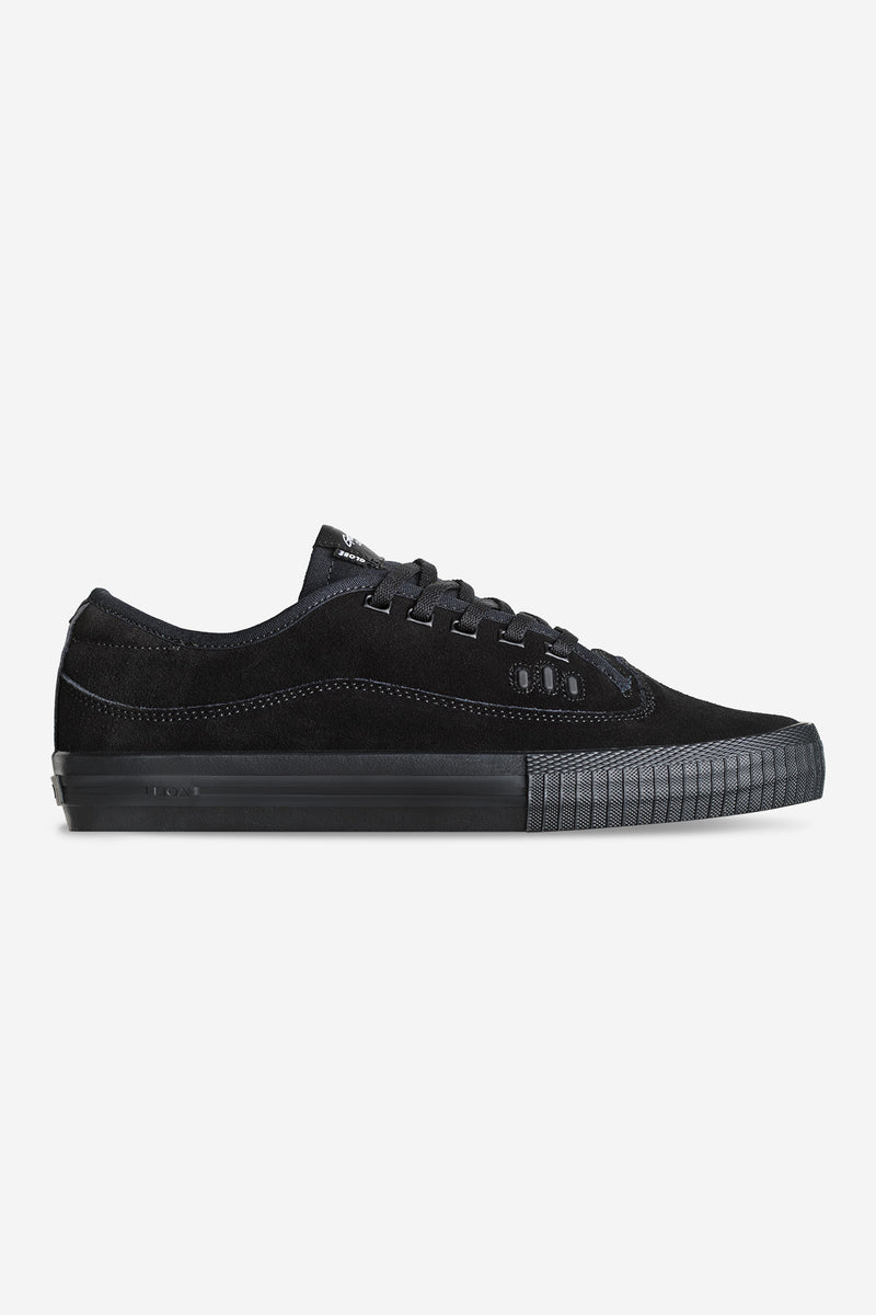 Gillette black suede sneakers with matching black sole, side profile.