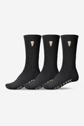 Three black crew socks with a small beige logo on the cuff and GILLETTE lettering on the toe.