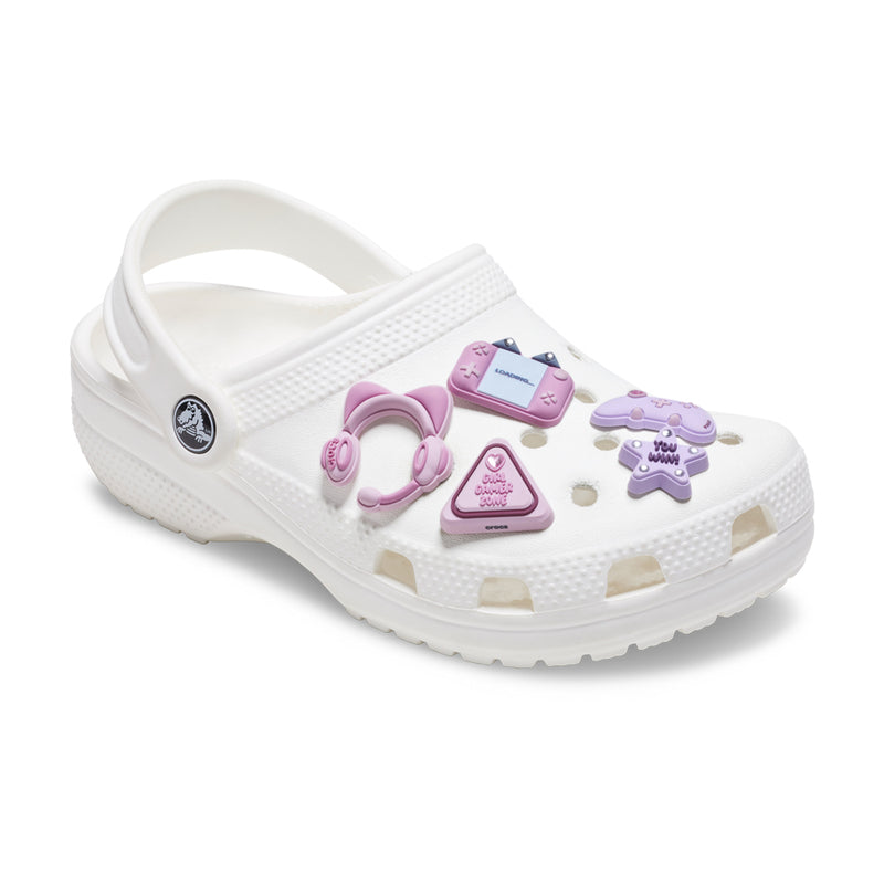 White clog with pink gaming Jibbitz charms: headset, controller, triangle badge, plus icons