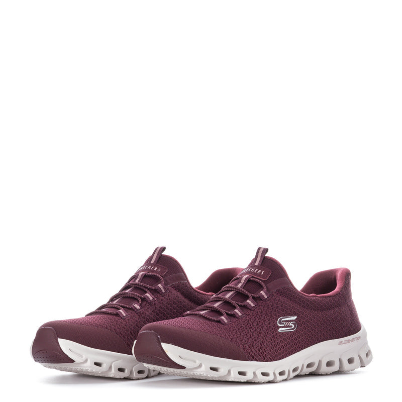 Burgundy sneakers with lace-up front, mesh texture, and white soles with molded pods
