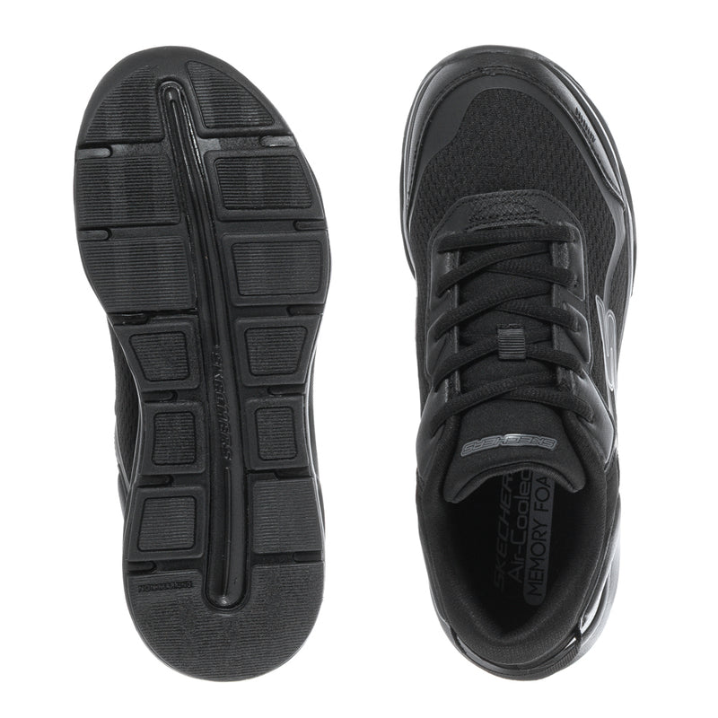 Black youth sneaker outsoles with tread pattern and lace-up upper view