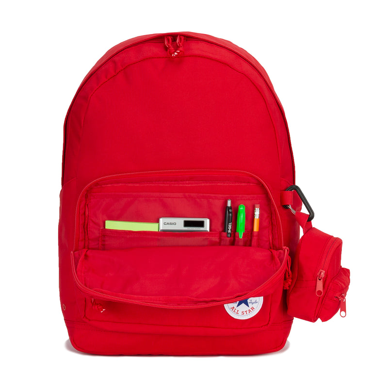 Red backpack with main zip, front organizer pocket with pens, and Converse All Star patch.