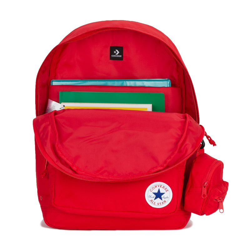 Red backpack open top showing interior mesh pocket and stacked notes, with Converse patch.
