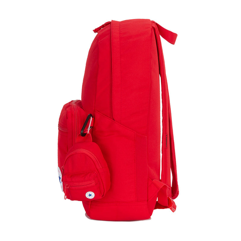 Red backpack side view with shoulder straps, front mini pouch, and Converse patch.