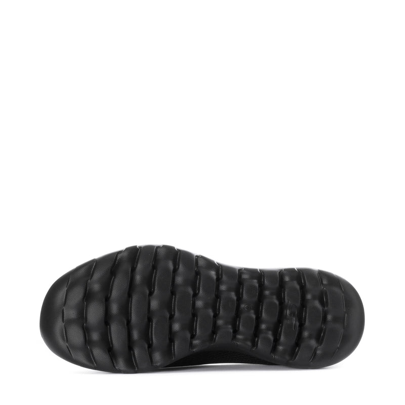 Women's black slip-on walking shoes, outsole view with textured tread pods