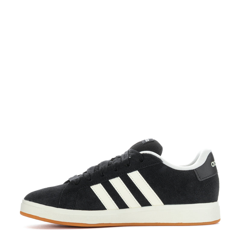 Black Adidas sneakers with white stripes and gum outsole, front-side angle.