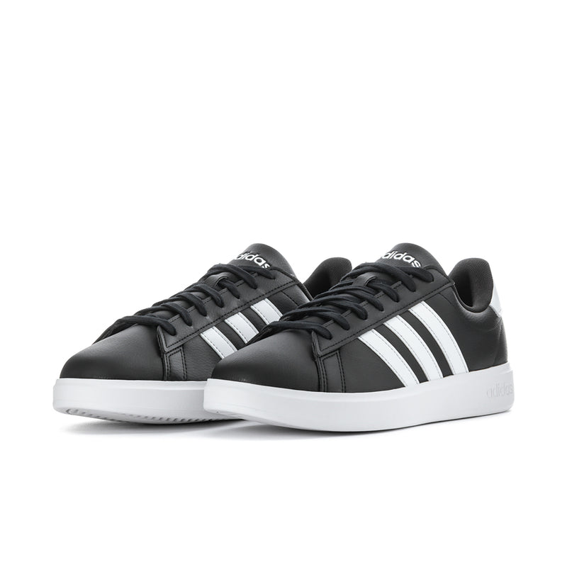 Pair of men's black adidas sneakers with white stripes and white rubber sole