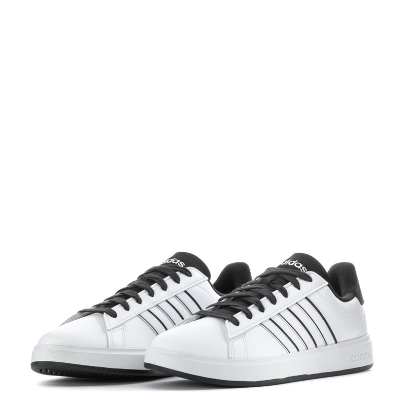 Pair of men's white sneakers with black three-stripe design and black lace-up uppers