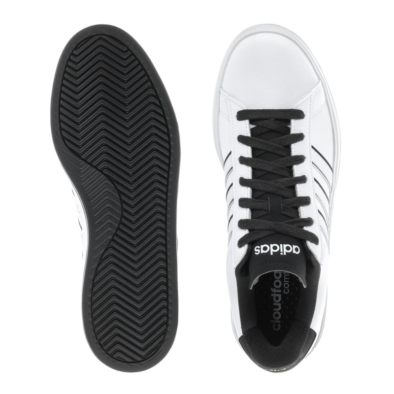 Sneaker outsole with black zigzag tread and white upper with black laces and tongue