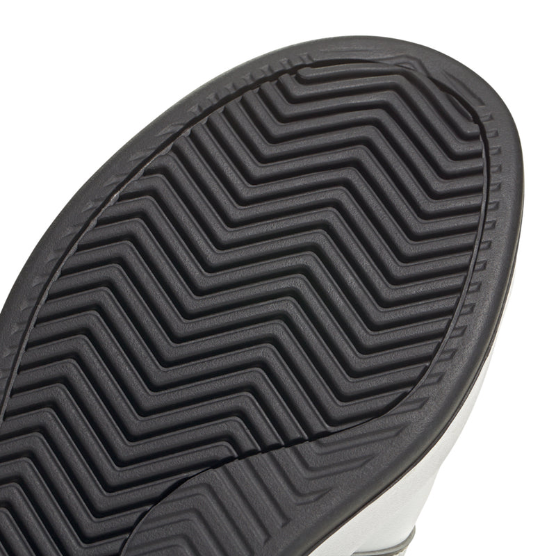 Black rubber outsole with zigzag tread pattern for white sneaker