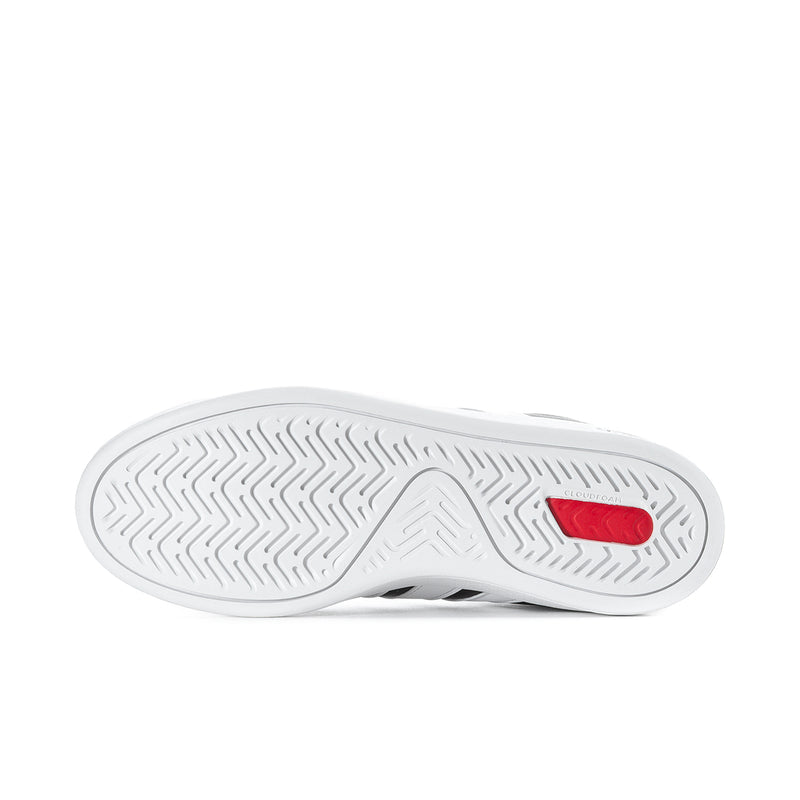 Shoe outsole with patterned tread and red traction insert for black sneakers