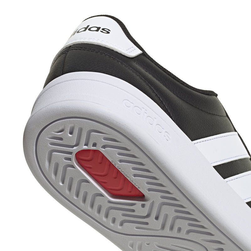 Rubber outsole with gray tread and red traction pad for black adidas sneakers