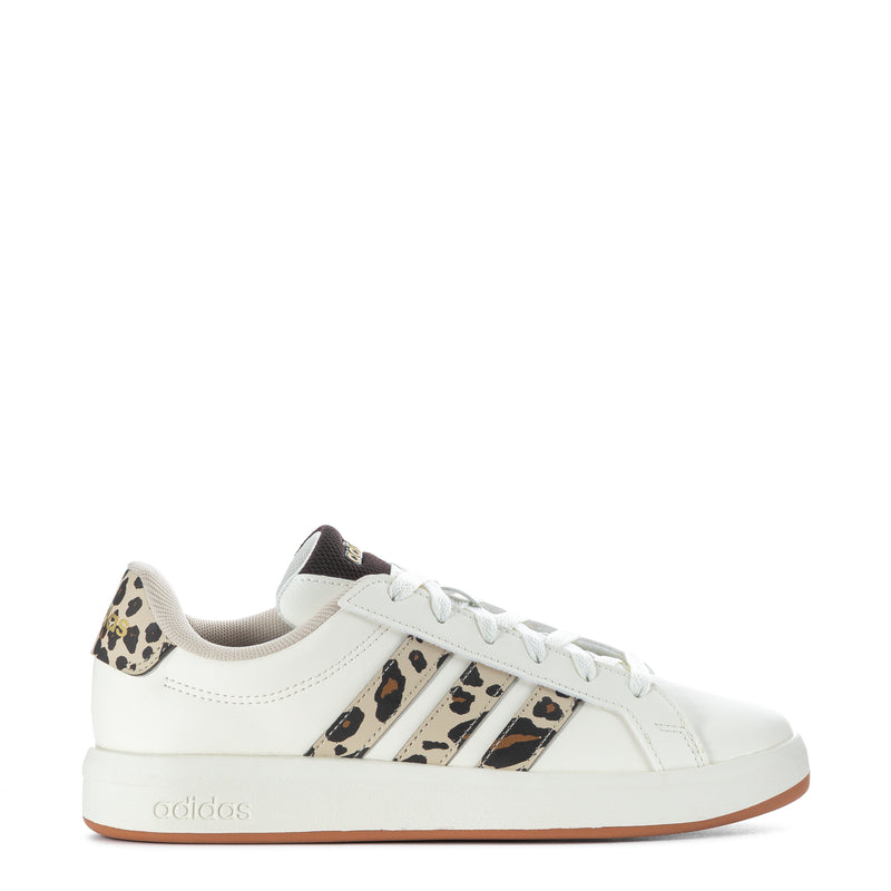 Youth low-top sneakers, white leather, leopard-print side stripes, tan gum sole.
