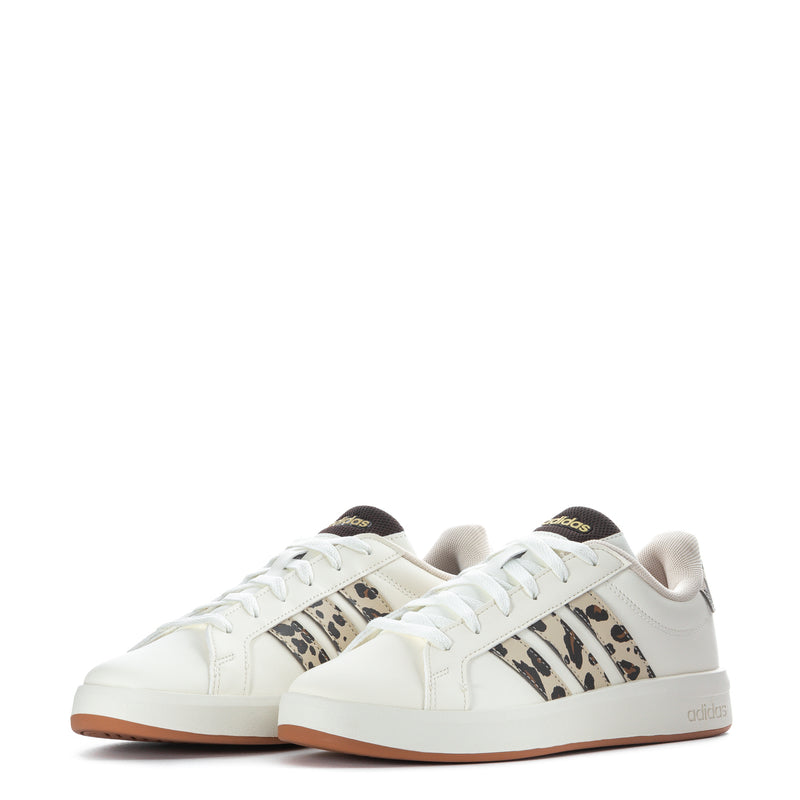 Pair of youth white lace-up sneakers with leopard-pattern three stripes and tan sole.