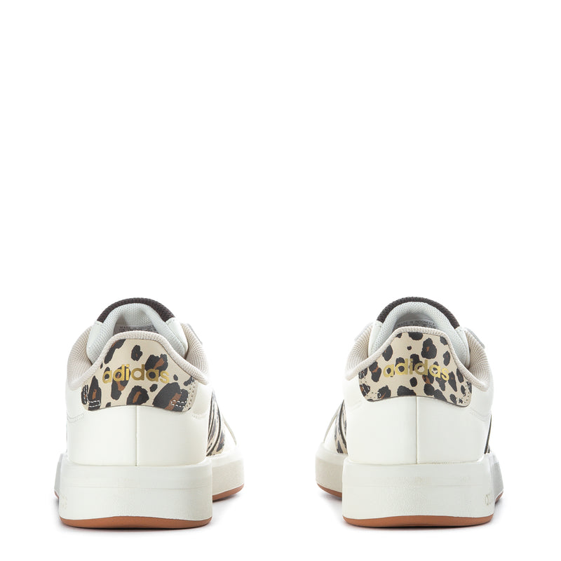 Youth adidas white sneakers with leopard heel panel and lace-up back, tan sole.