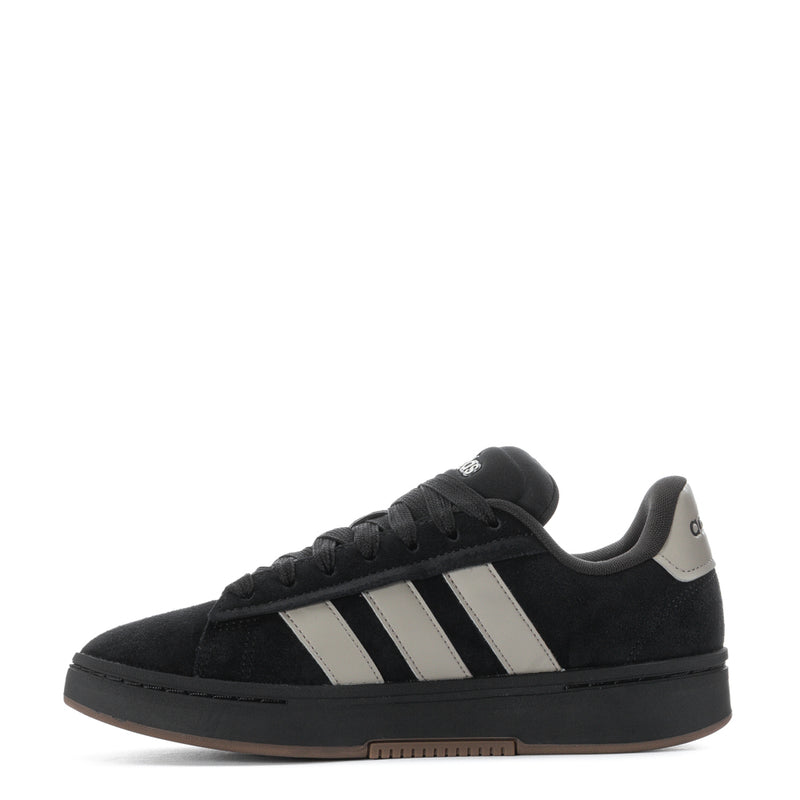 Men’s black low-top adidas sneaker with white adidas stripes and gum sole