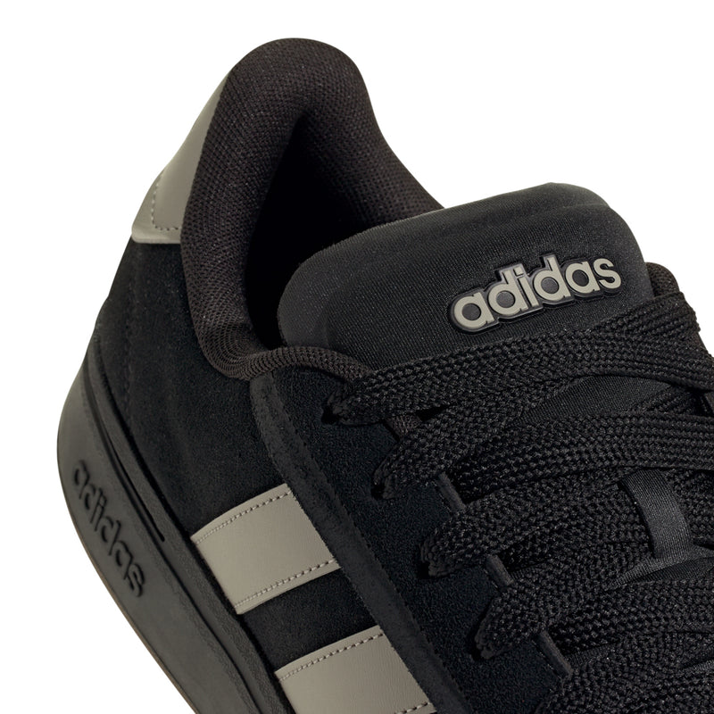 Men’s black adidas sneaker upper detail with knit texture, laces, and adidas logo