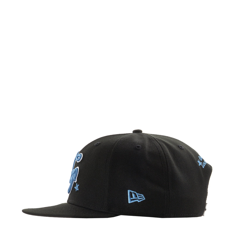 Black baseball cap with blue side embroidery and New Era logo at center front