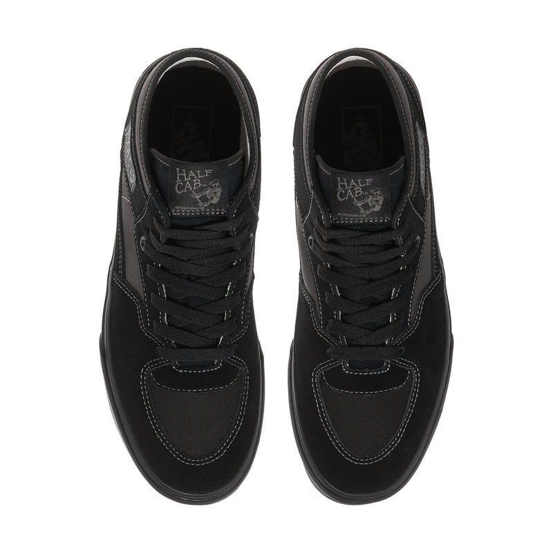 Men's black high-top sneakers, top view showing lace panel and logo on tongue