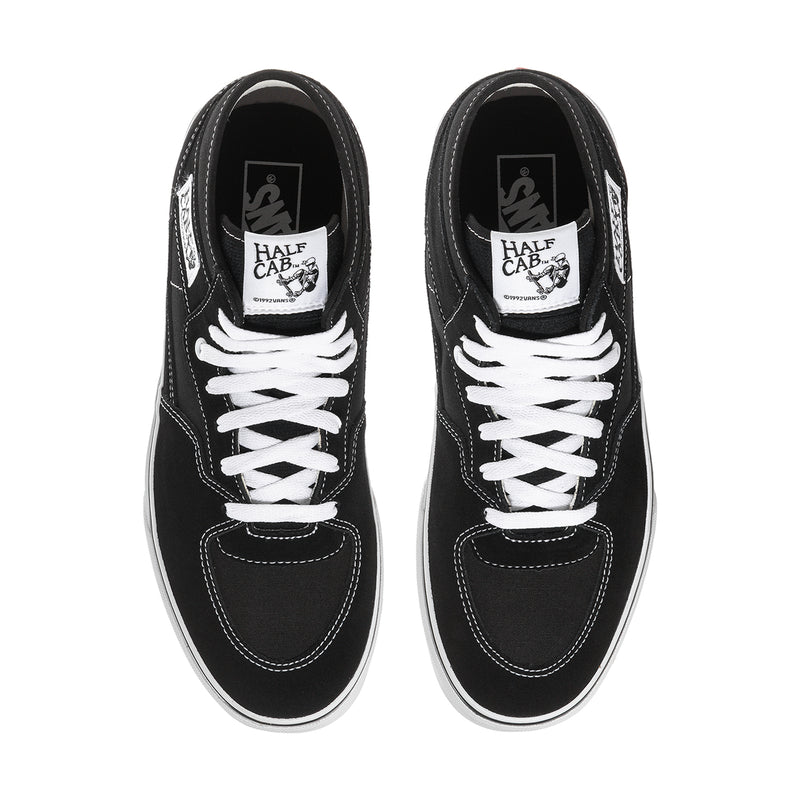 Black canvas high-top sneakers with white lace-up front and padded tongue