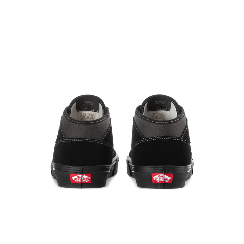 Men's black high-top sneakers from heel view with cushioned back and red label