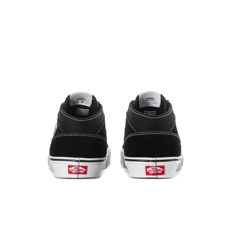 Black canvas high-top sneakers, back view, white rubber sole and heel tab