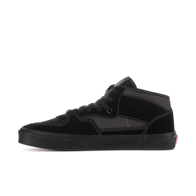 Men's black high-top sneakers side view with ankle strap and contrast stitching