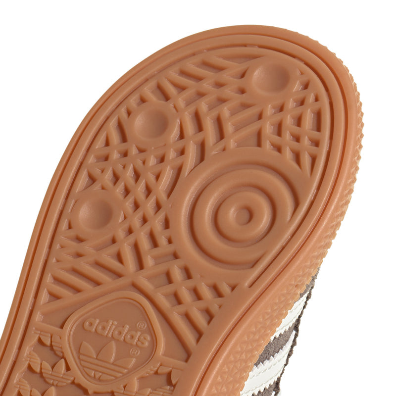 Close-up gum outsole tread with adidas logo and molded grip pattern