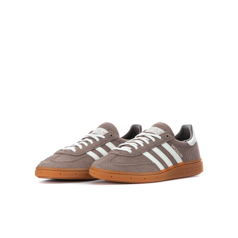 Youth sneakers pair, brown suede uppers, cream stripes, orange gum outsole.