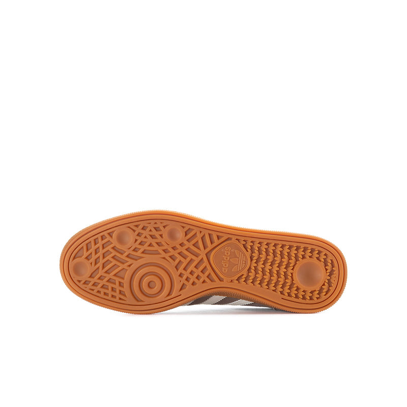 Youth sneaker outsole, orange gum tread with patterned rubber details.