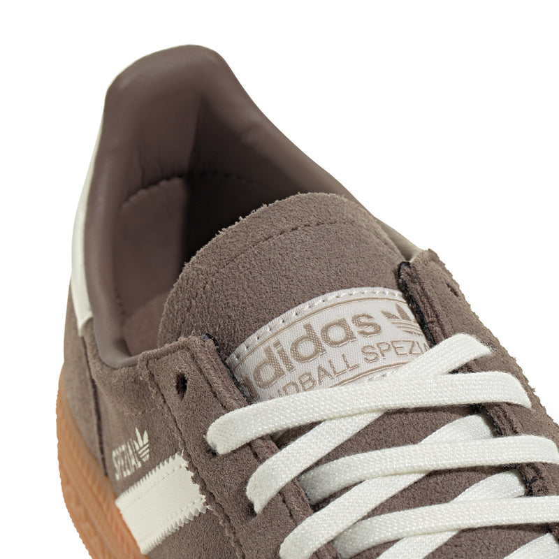 Youth sneaker heel and tongue, brown suede with adidas logo and cream laces.