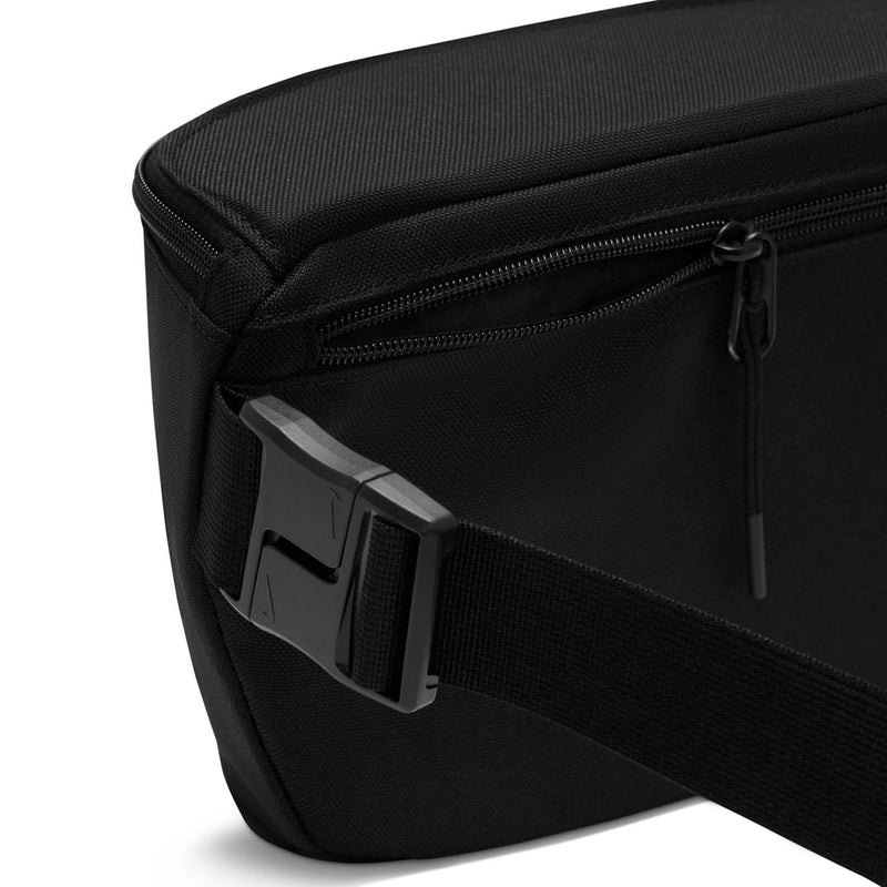 Black waist pack close-up: textured fabric with zipper track and pull tab.