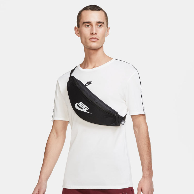 Black crossbody waist pack with Nike logo on chest and zippered front
