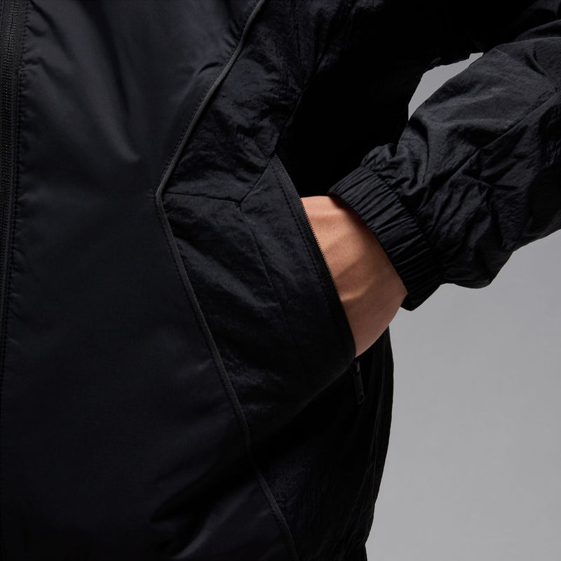 Black hooded draft jacket detail with side pocket and elastic cuff