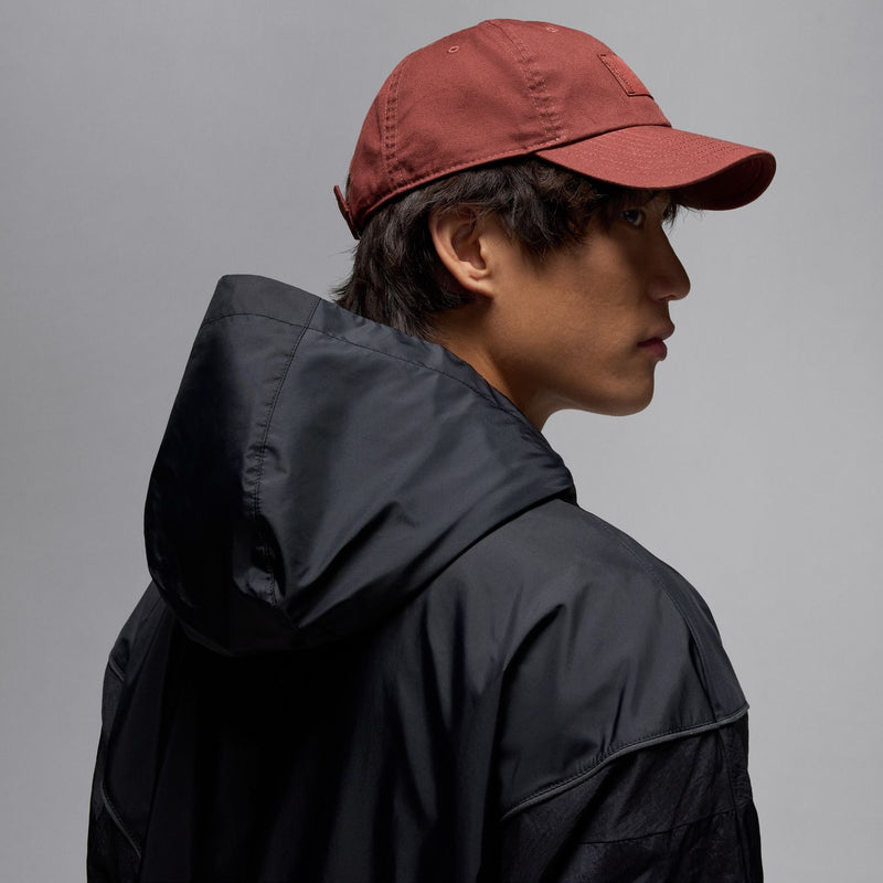Black hooded draft jacket side view with adjustable hood and seam panel