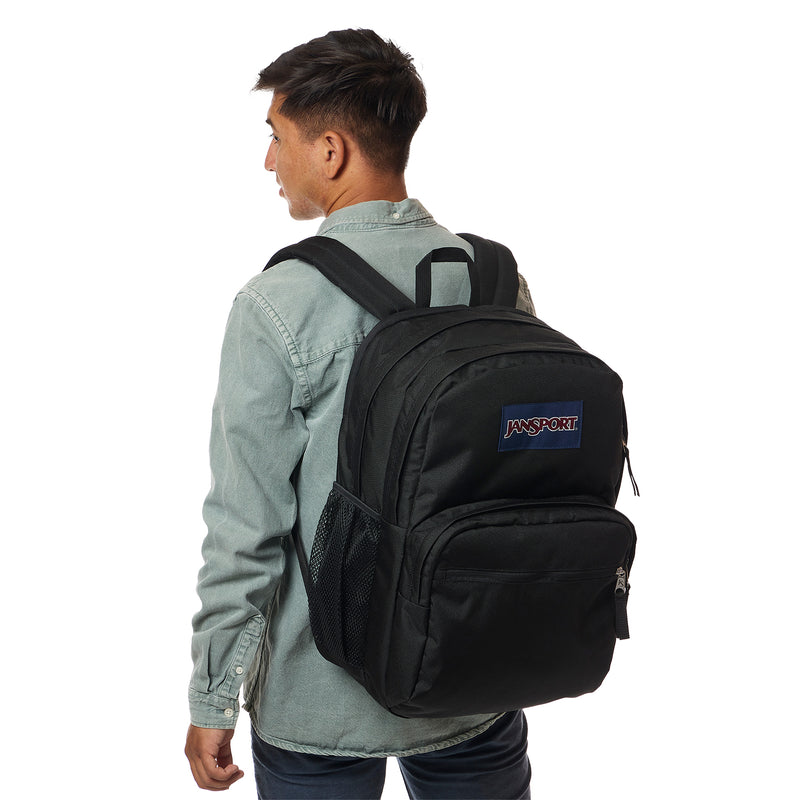 Black Jansport backpack worn by person, with side mesh pocket and front zip