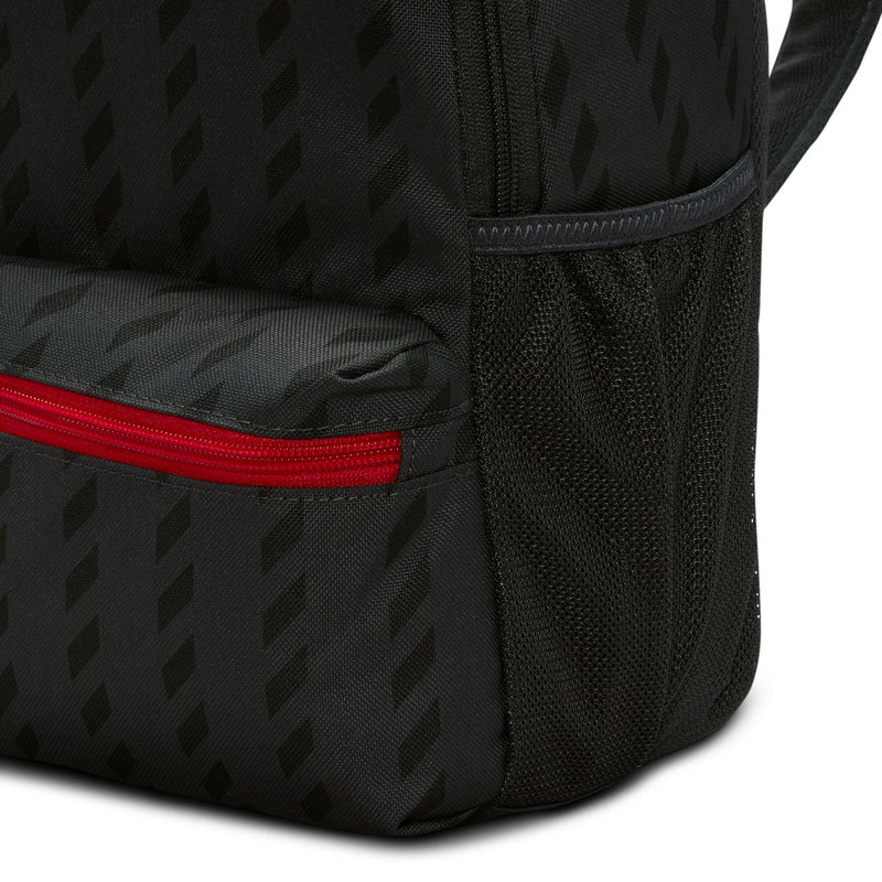 Mini black backpack side with red zipper trim and textured fabric panel